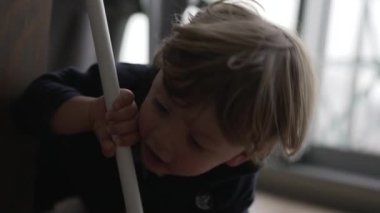 Child getting up from floor. Toddler two year old baby gets up