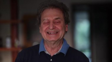 Happy older man smiling at camera. Portrait close-up senior in 60s