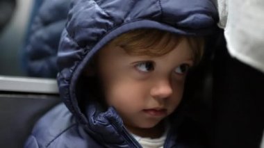 Bashful toddler hiding behind cloth