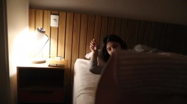 Woman getting out of bed in the middle of the night