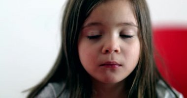 Little girl sad face emotion close-up portrait