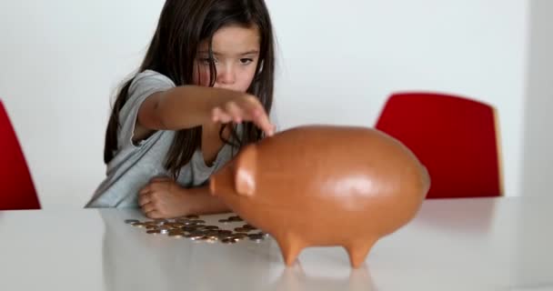 Little Girl Adding Coins Piggy Bank Child Saving Money Concept — Video