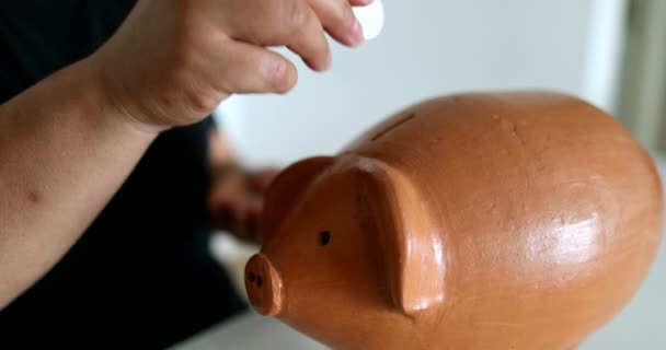 Close Black Person Hands Putting Coins Piggy Bank — Vídeo de Stock