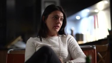Candid woman in conversation at night, casual real life