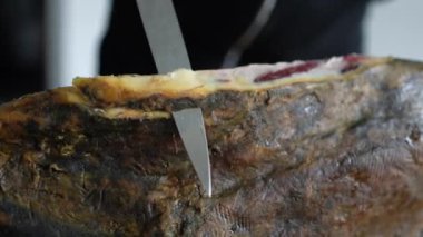 Slicing jamon serrano ham, traditional spanish meat culture