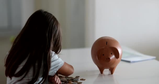 Little Girl Adding Coins Piggy Bank Child Saving Money Concept — стоковое видео