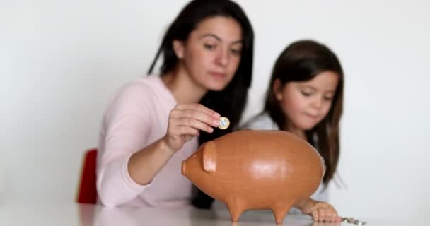 Mother Daughter Financial Savings Adding Coins Piggy Bank — Stockvideo