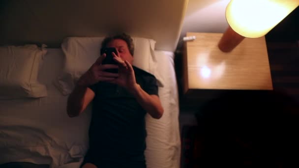 Senior Man Turning Bedside Lamp Grabbing Cellphone Middle Night — Stock videók