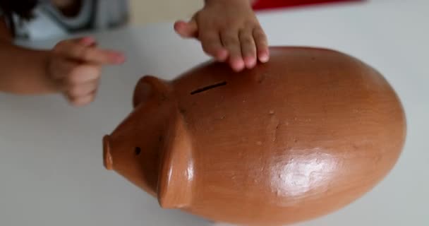 Little Girl Adding Coins Piggy Bank Child Saving Money Concept — стоковое видео