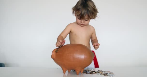 Child Putting Coins Savings Piggy Bank — Vídeo de Stock