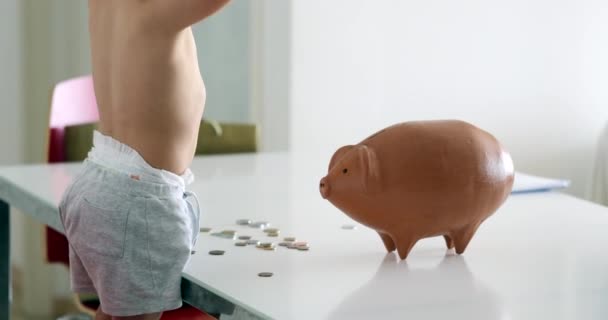 Cute Baby Boy Adding Coins Piggy Bank Child Saving Money — стоковое видео