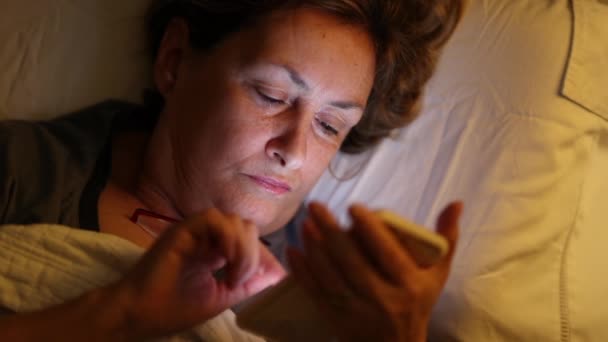 Older Woman Reading Cellphone Night Bed Turning Night Lamp Going — Stock videók