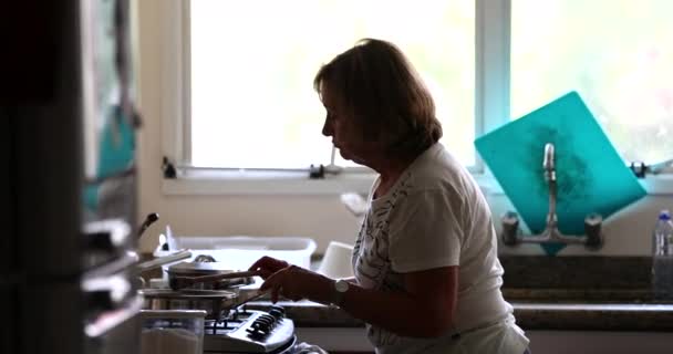 Candid Older Woman Cooking Home Casual Real Life — Vídeo de Stock