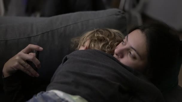 Mother Looking Cellphone Toddler Baby Naps Embracing Mom — Vídeo de stock