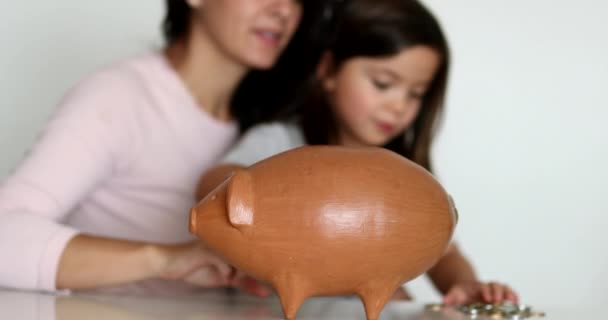 Mother Daughter Financial Savings Adding Coins Piggy Bank — Vídeos de Stock