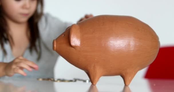 Little Girl Adding Coins Piggy Bank Child Saving Money Concept — Vídeos de Stock