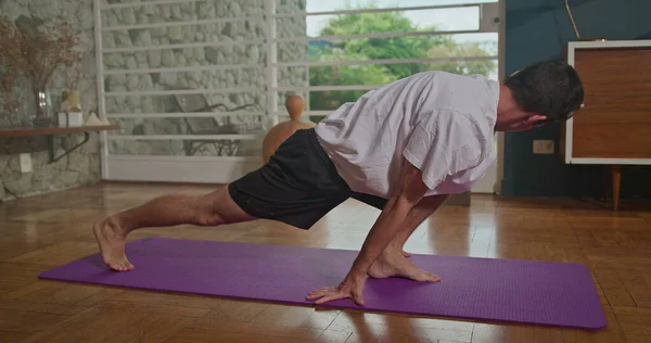 Man Stretches Mat Living Room Practices Yoga Does Flexibility Exercises — 图库照片