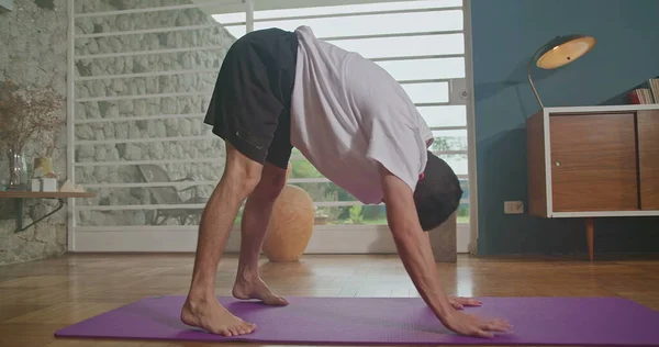 Man Stretches Mat Living Room Practices Yoga Does Flexibility Exercises — Stock Photo, Image