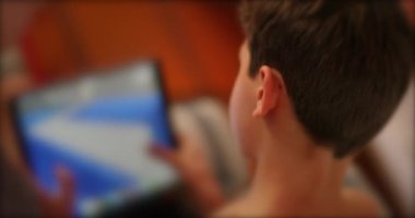 Child perspective playing video-game on tablet device