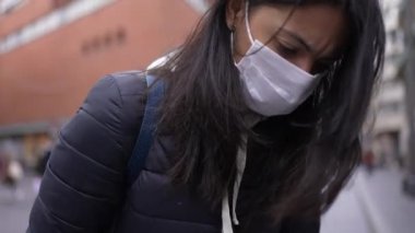 Mother and baby at city downtown during covid-19 time period wearing face mask