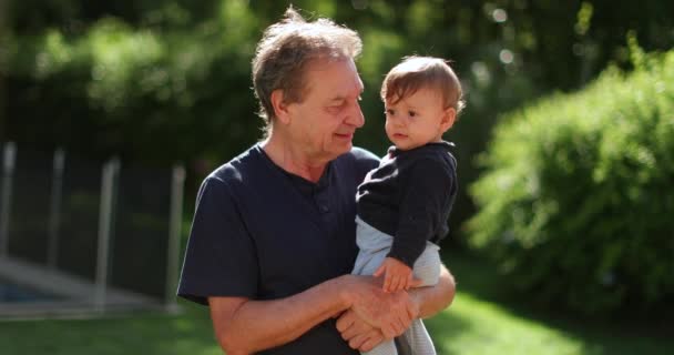 Senior Man Holding Infant Baby Grand Father Bonding Toddler Outdoors — Stock video