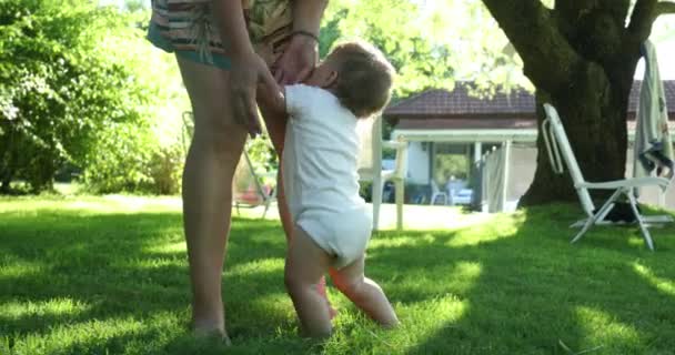 Baby Holding Mother Legs Outdoors — Stock Video