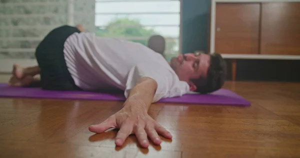Man Stretches Mat Living Room Practices Yoga Does Flexibility Exercises — Stok fotoğraf