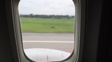 Plane window passenger POV taking off