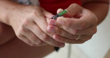 Parent trimming baby nails. Mother cutting crying infant nail