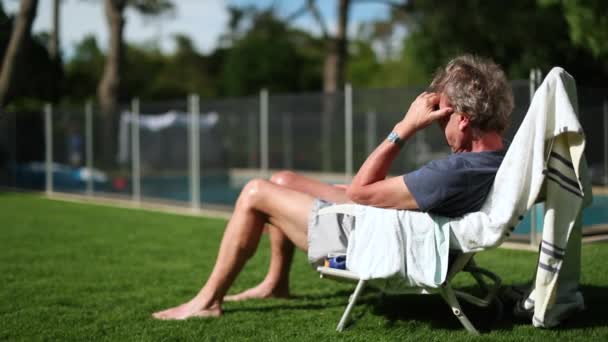 Older Man Resting Sitting Chair Overlooking Home Garden Enjoying Sunlight — Stockvideo