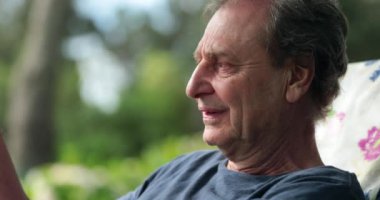 Senior man in conversation outside natural and candid moment