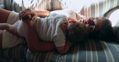 Gerçek hayatta anne kanepede uyuyan bebeğe sarılıyor.