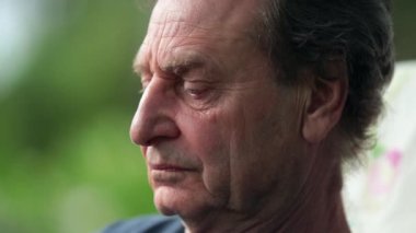 Older man paying attention, senior man turning head listening