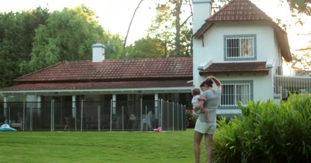 Exterior Residential Home Mother Carrying Baby Walking House — Stockvideo