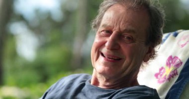 Smiling happy older retired senior man outside