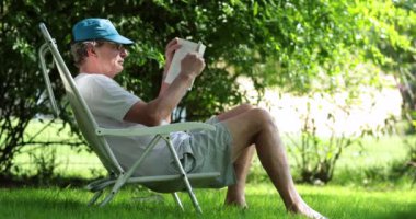 Man reading book story outside in nature