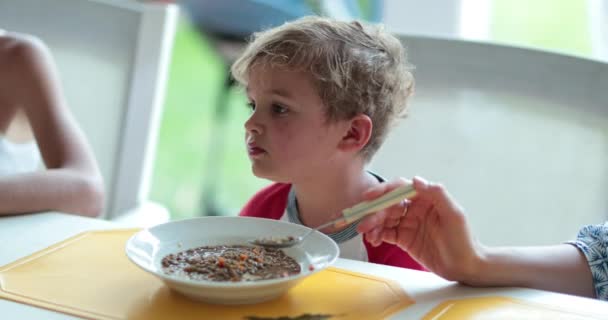 Chłopiec Siedzący Przy Stole Jedzeniem — Wideo stockowe