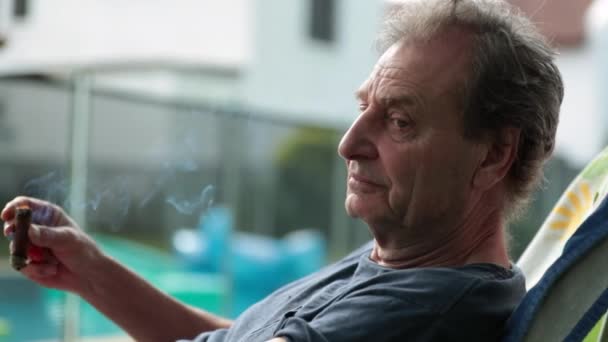 Serious Thoughtful Older Man Backyard Holding Cigar — Stok video