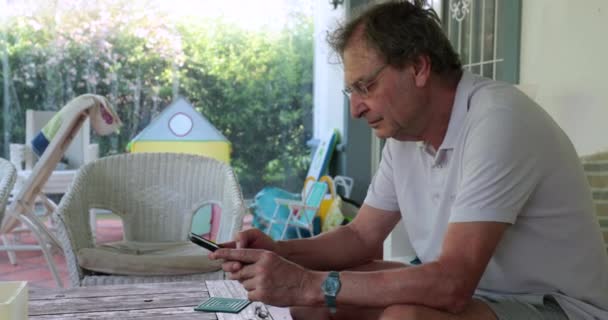 Candid Older Man Using Smartphone Device Casual Senior Home — Αρχείο Βίντεο