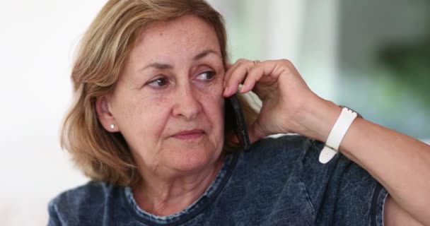 Older Woman Listening Attentively Phone Conversation — стоковое видео