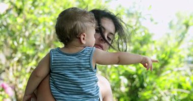 Tired mother with baby outside
