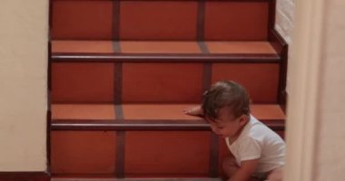 Baby crawling towards camera on home floor