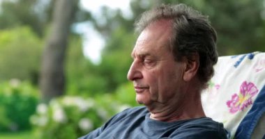 Pensive senior man thinking about life. Contemplative thoughtful older man outdoors