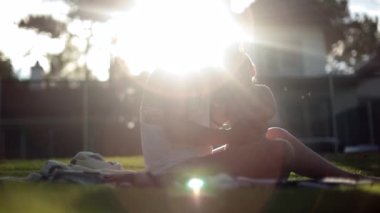 Dreamy lens-flare outdoors with mother and baby infant together in dreamlike scene