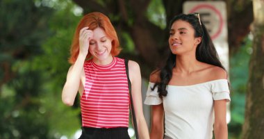 Şehir kaldırımında yürüyen genç kadınlar. Şehir kaldırımında yürüyen çok ırklı arkadaşlar