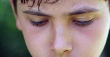 Pensive child close-up eyes thinking. Thoughtful young boy wondering