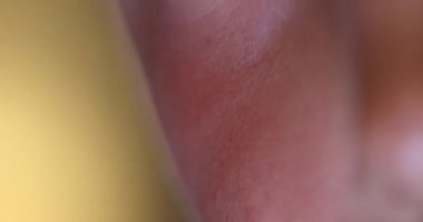 Close-up of child eyes staring at screen. Macro red eye looking at blue light at night