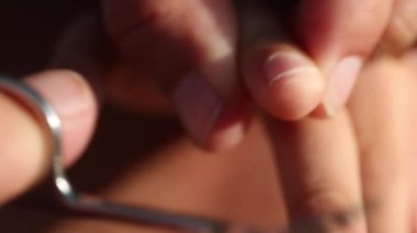 Parent cutting child nails. Mother trimming kid hand nail
