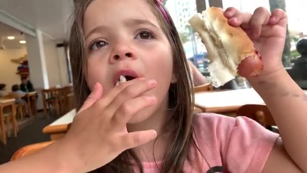 Child Girl Eating Hotdog Meal — Stock Video