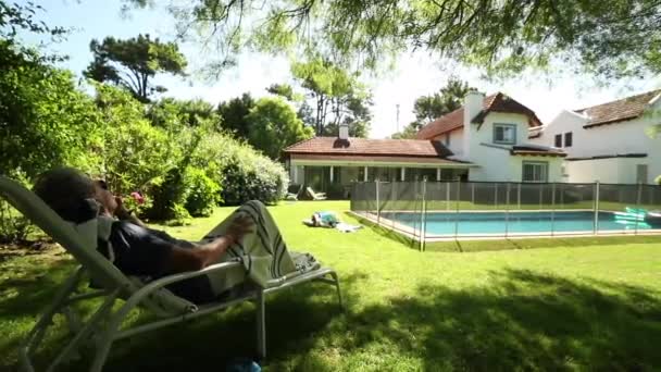 Older Man Resting Backyard Residential Home Senior Person Relaxing Outdoors — Stock Video